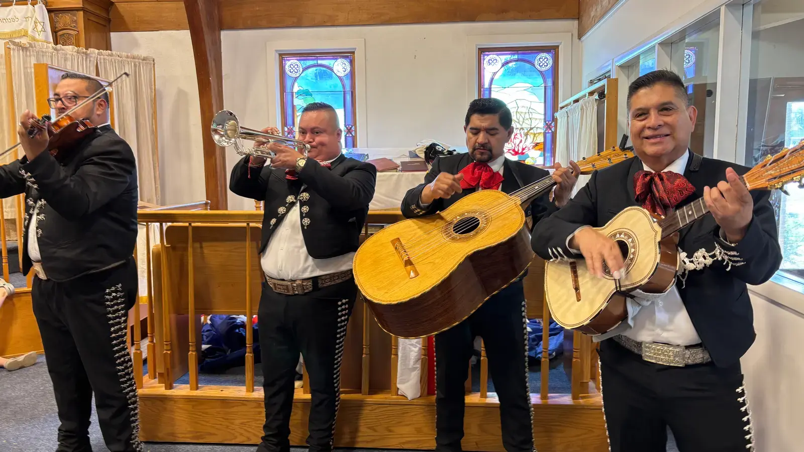 A mariachi band performing for campers in the synagogue on Mexican theme day