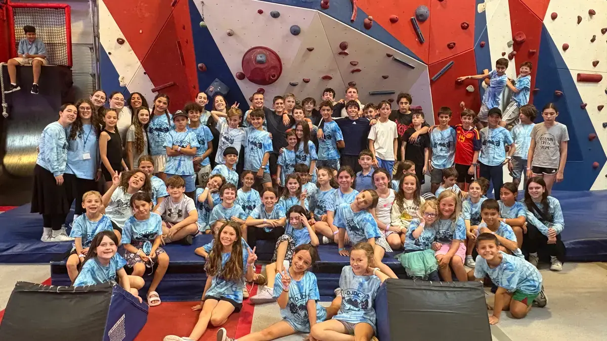 The whole camp gathered on the bleachers at the climbing gym
