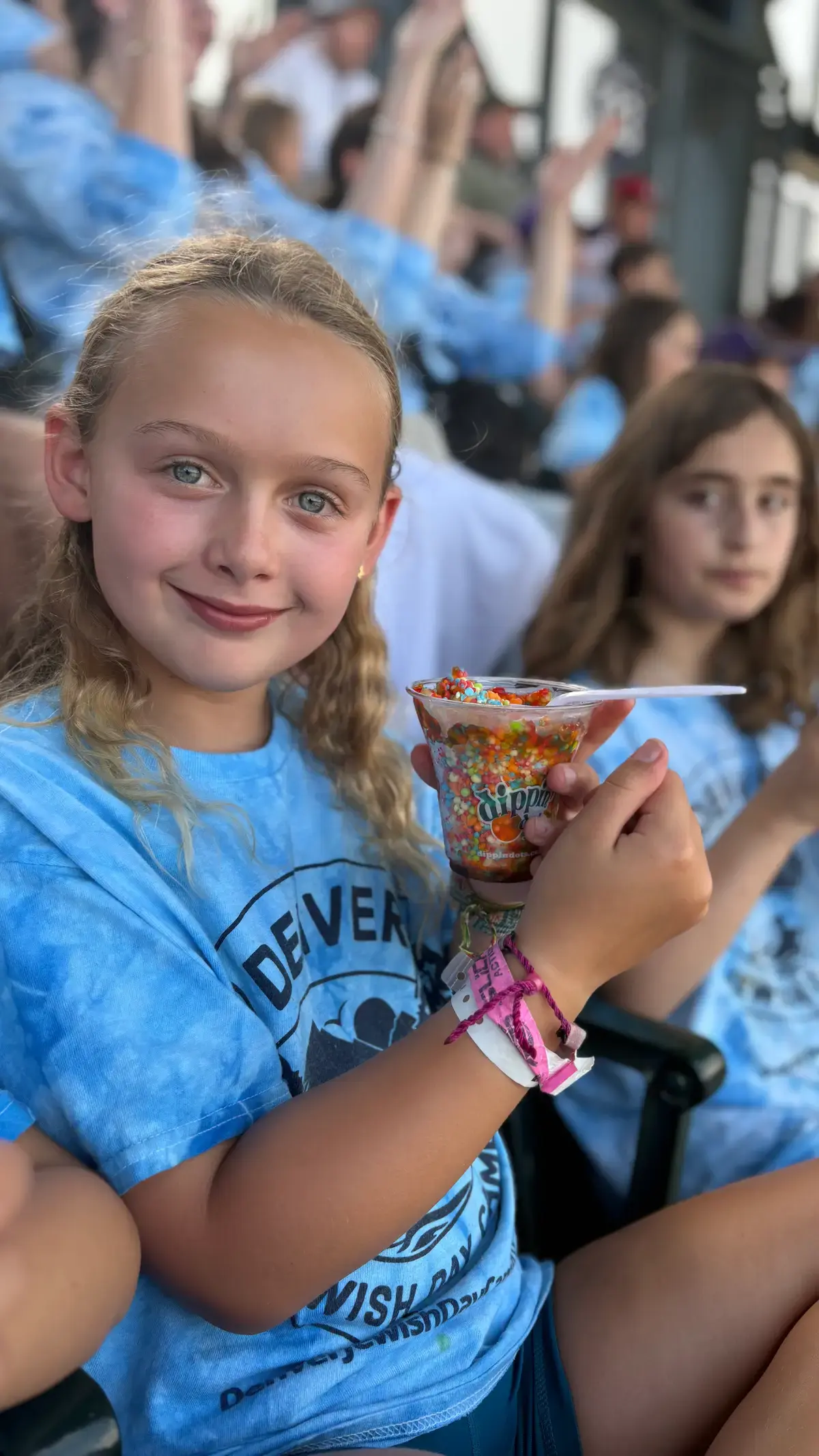 Camper smiling over an ice-cream sundae on a trip