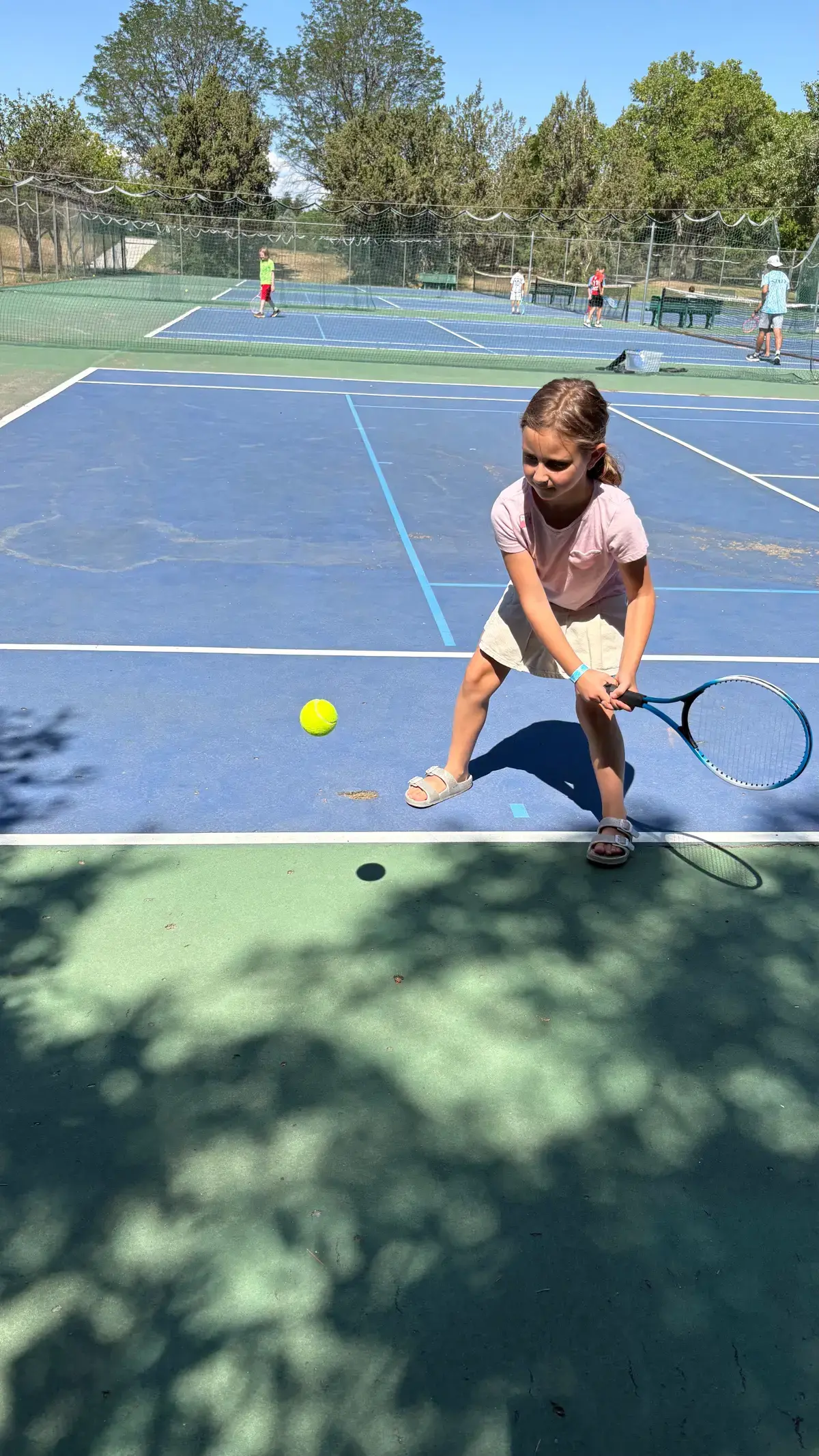 Camper lining up a backhand at tennis